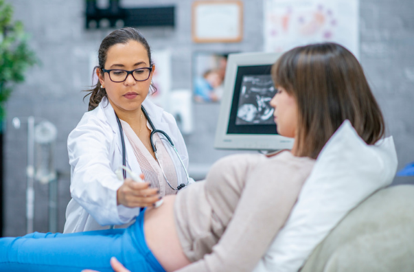 doctor performing an ultrasound on woman's uterus