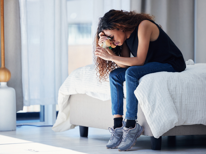 woman hunched over in grief