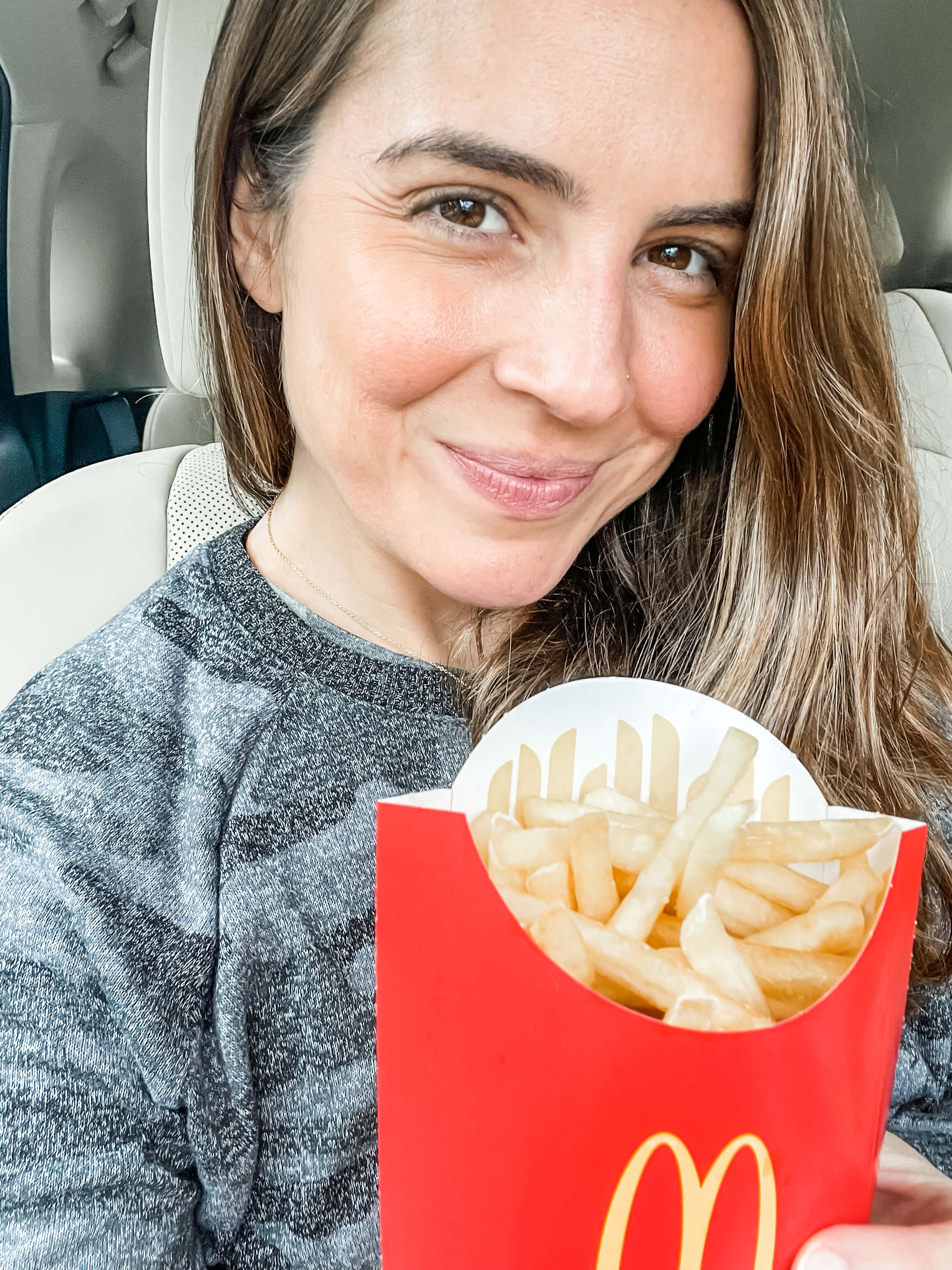 kristyn hodgdon eating mcdonald's french fries during the ivf two-week wait