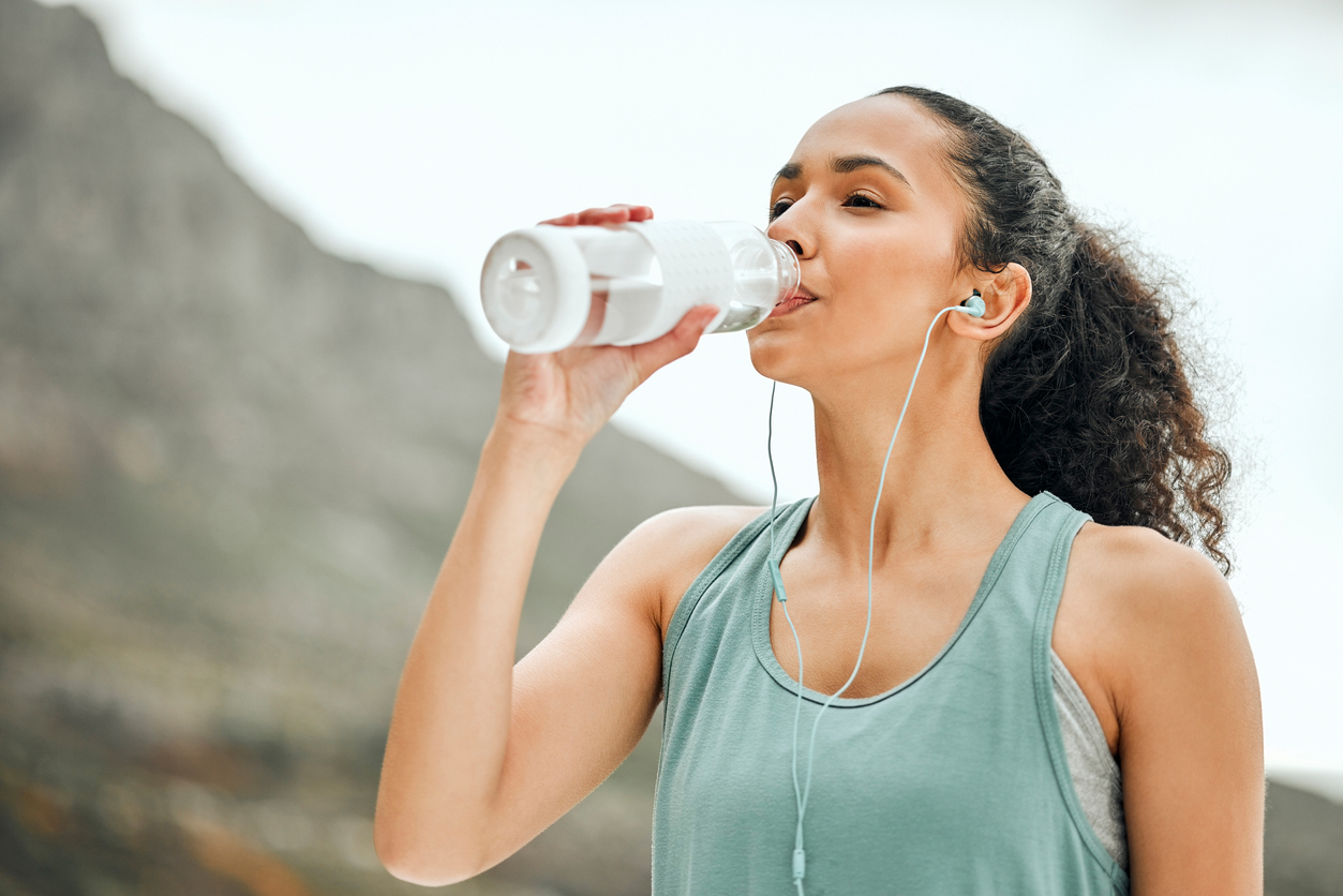 woman drinking water after a workout