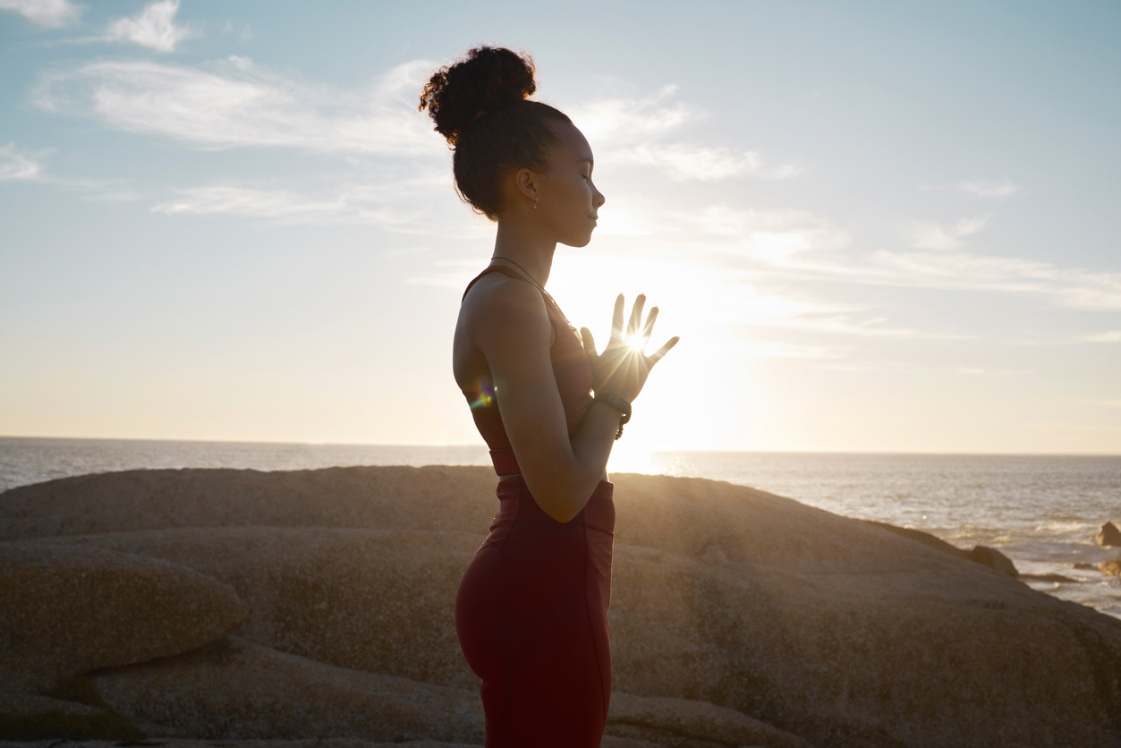 woman reflecting by the ocean