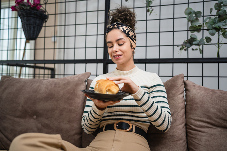 woman eating a croissant