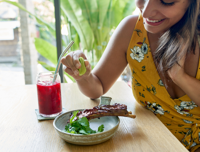 woman eating ribs