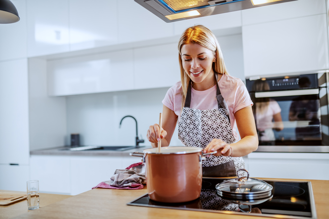 woman cooking over the stove top