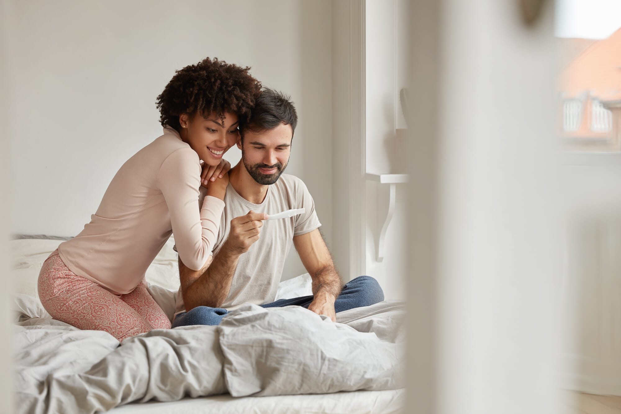 couple looking at the results of an ovulation predictor kit