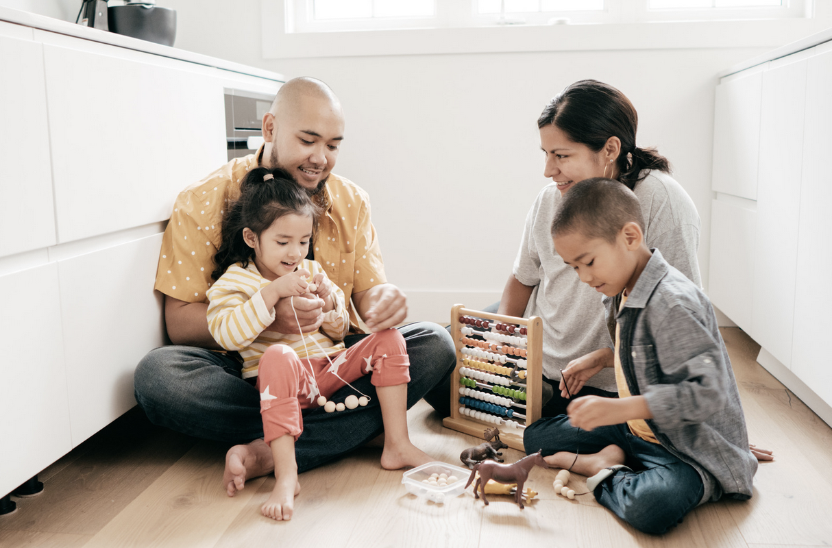 a family playing on the floor together