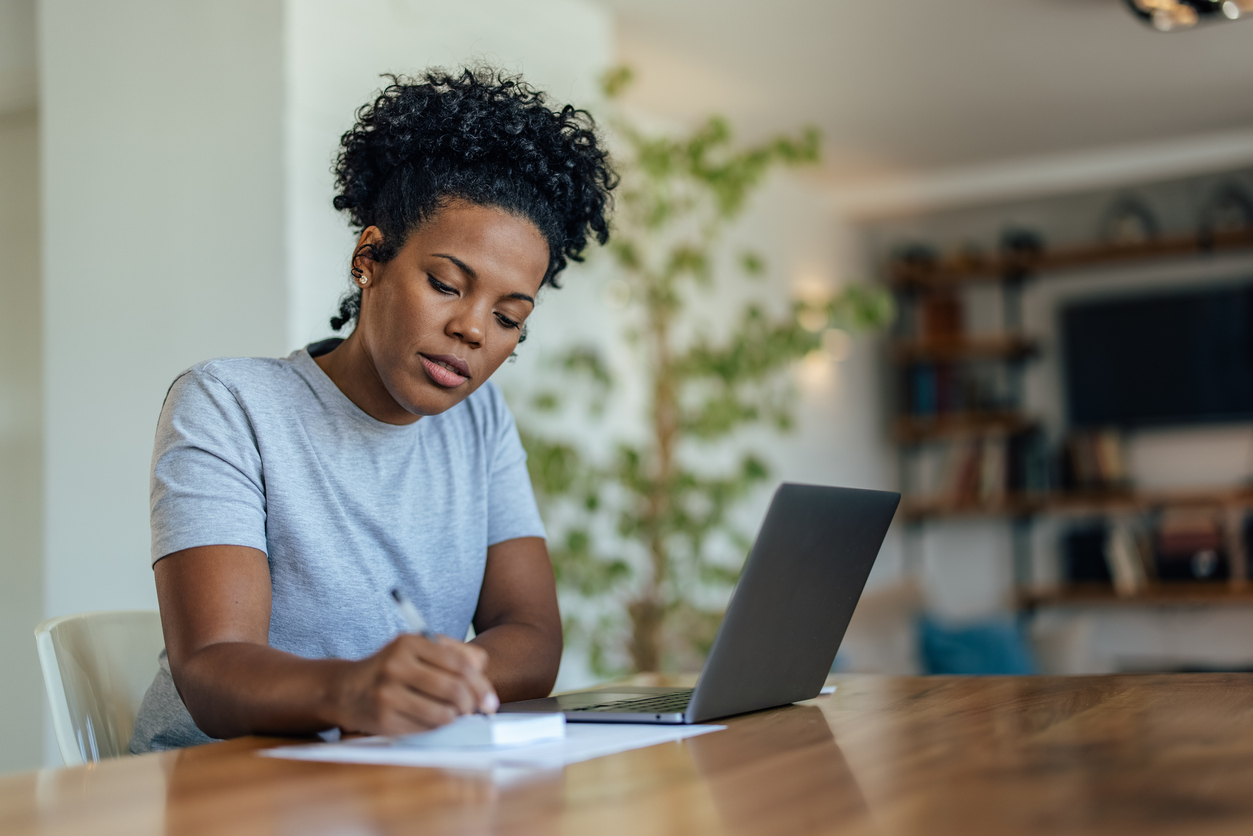 woman researching fertility benefits on her laptop