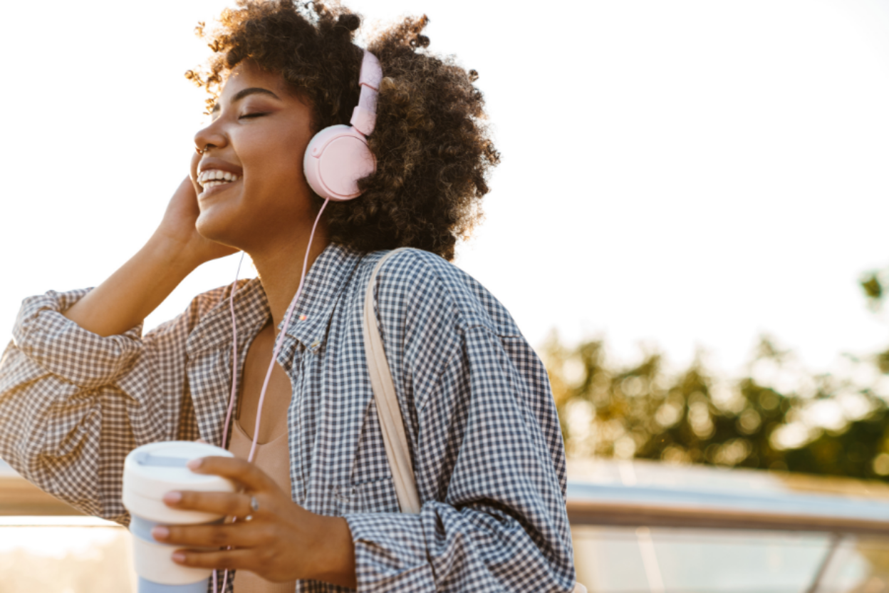 woman listening to music while having her morning coffee