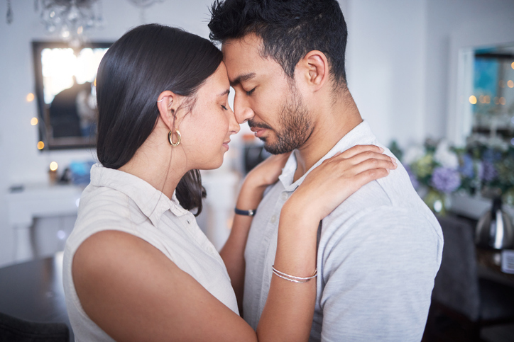 grieving couple holding each other