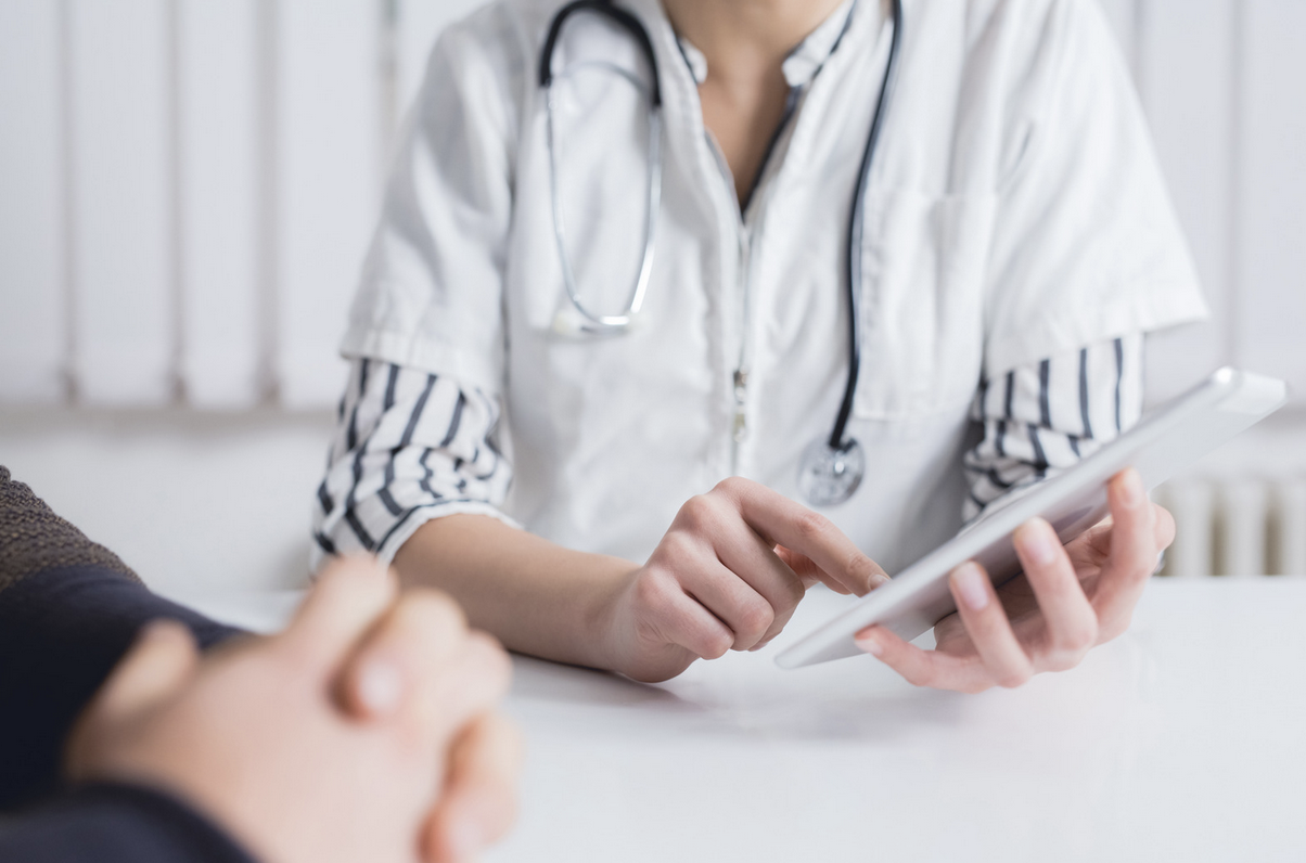 doctor showing patient lab results on a tablet