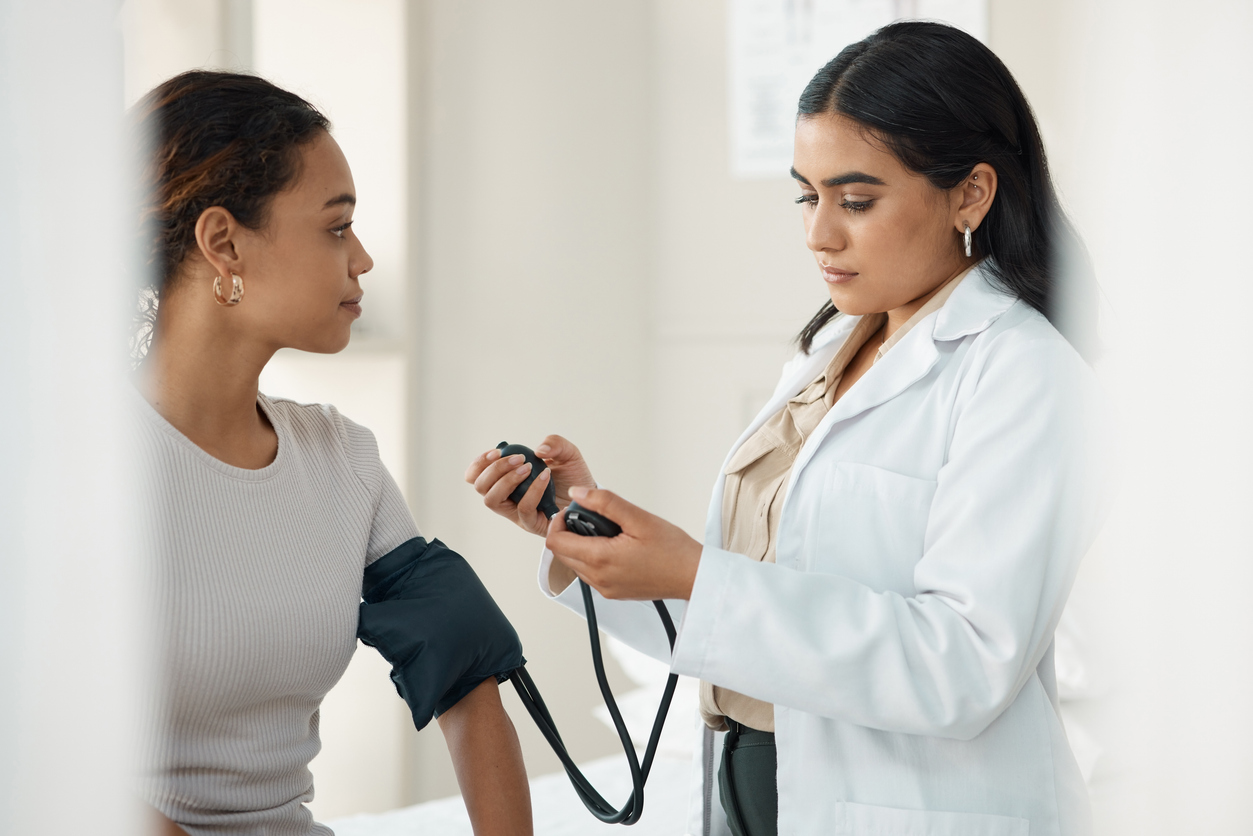 medical assistant monitoring a patient's blood pressure