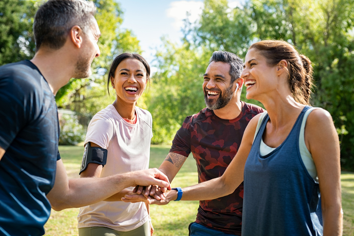 two couples working out together outdoors