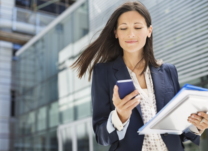 business woman reading a text on her mobile phone