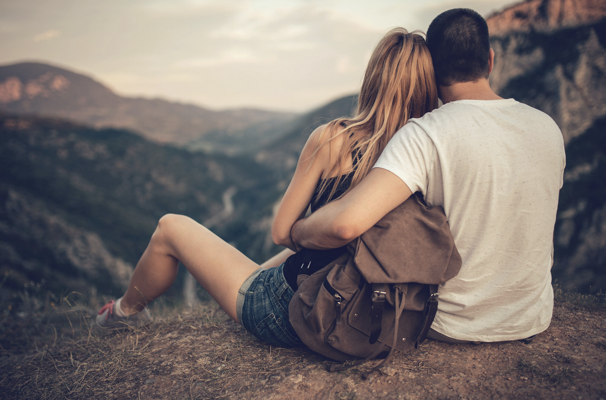 couple relaxing enjoying the vista during a hike