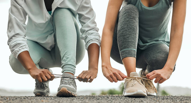 women tying their running shoes