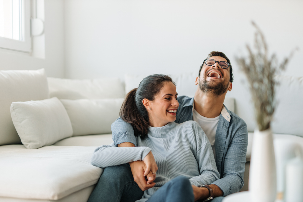 couple laughing on the living room floor