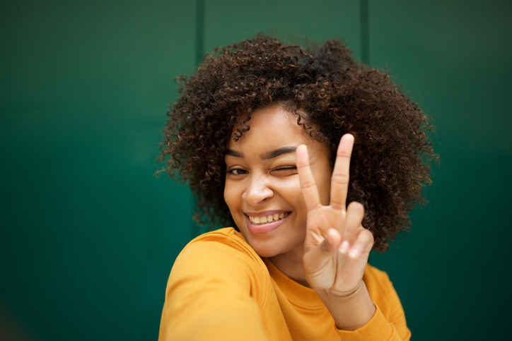 woman holding up two fingers to represent transferring two embryos