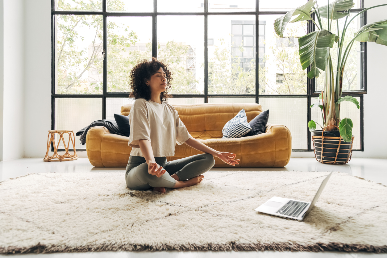 woman meditating in her living room