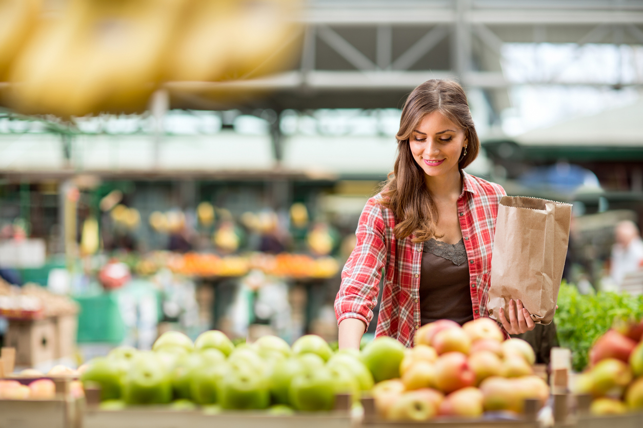 woman selecting apples at the grocery store