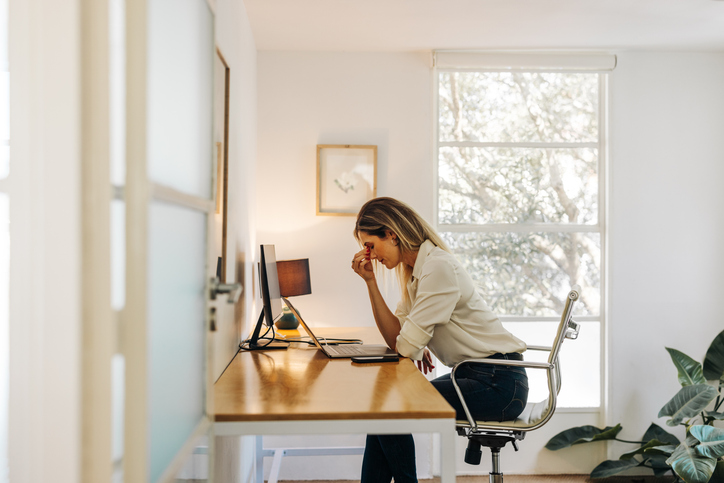 woman in pain at her desk