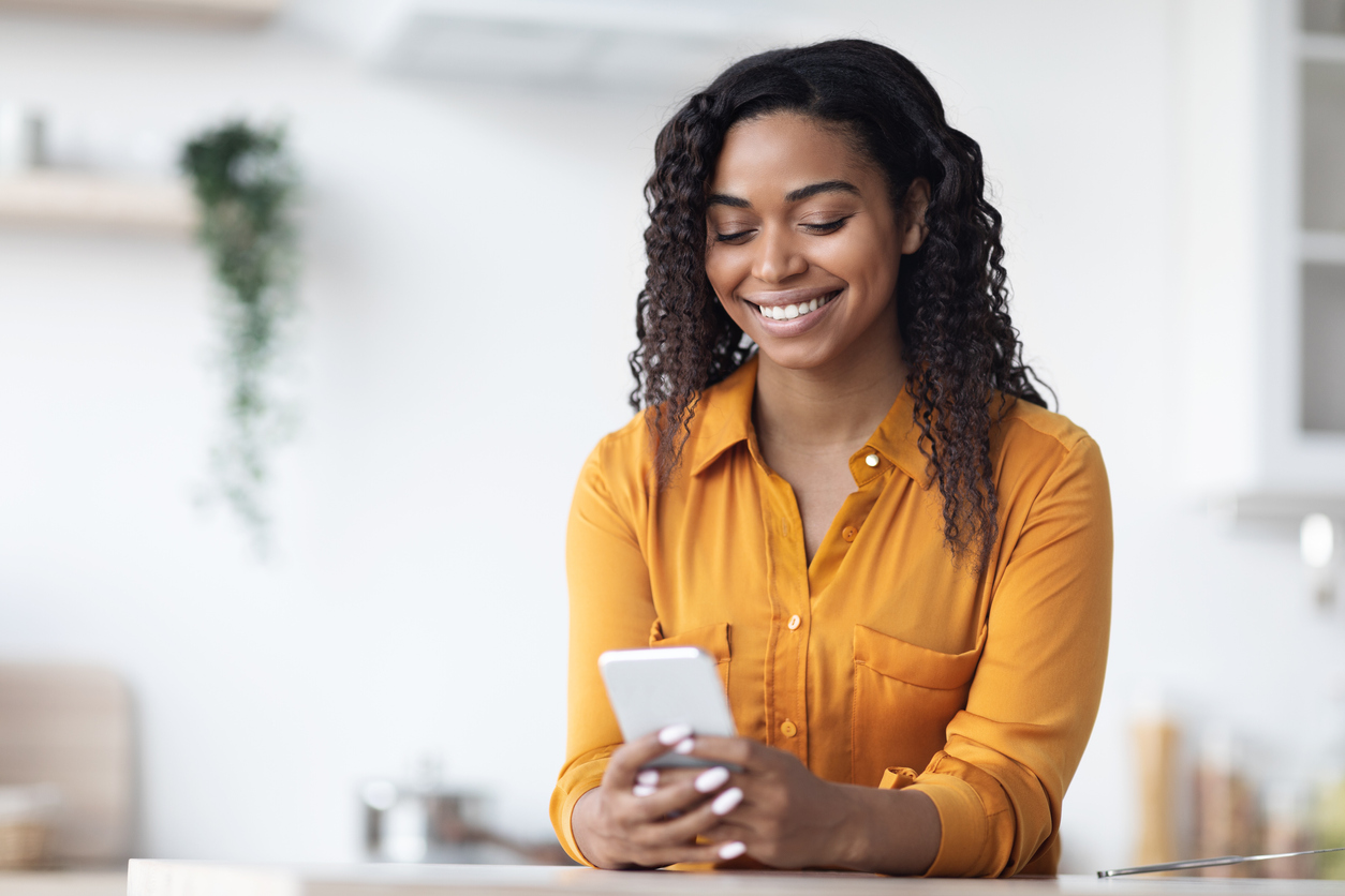 woman using her phone to track cervical mucus