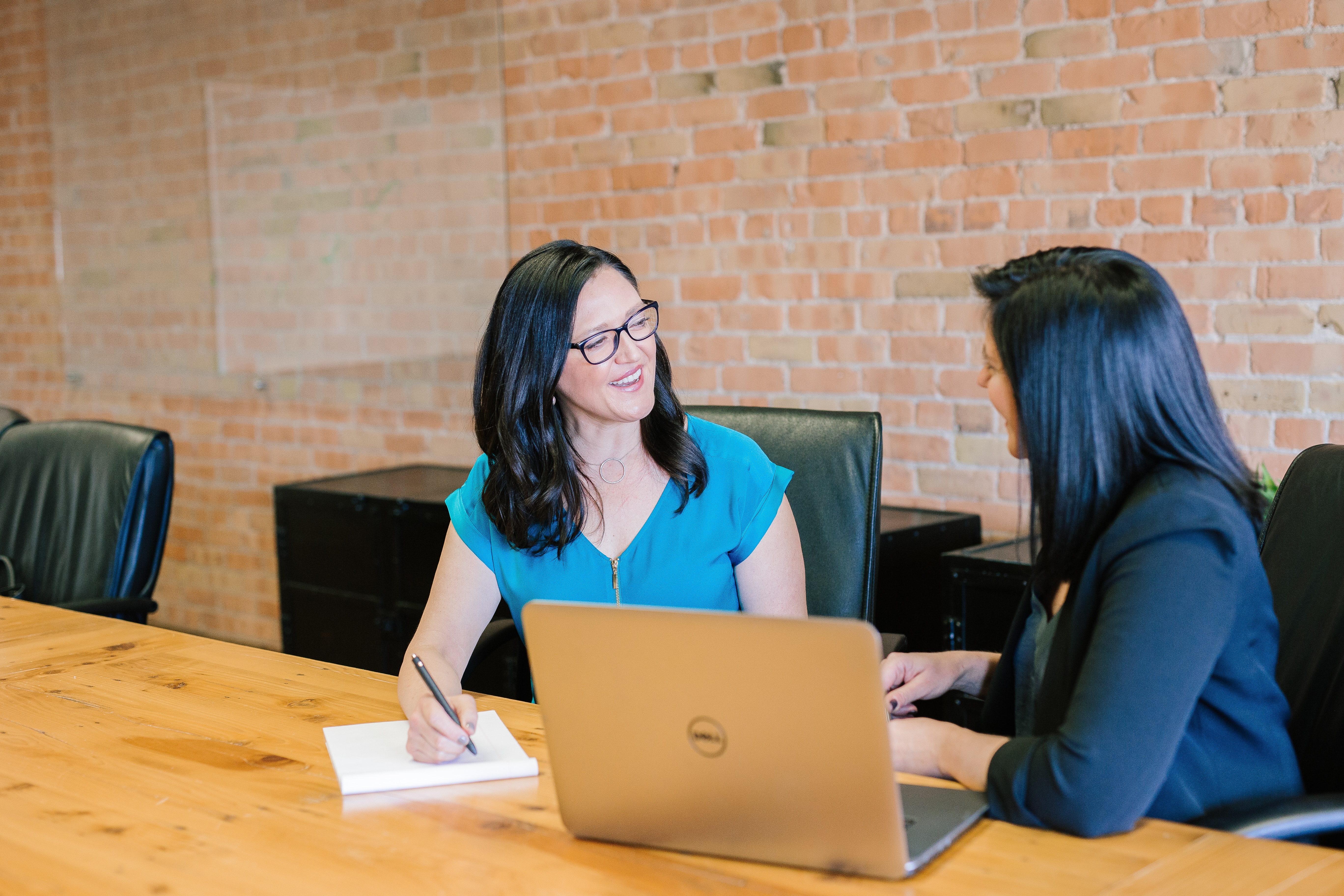 two women talking in a professional setting