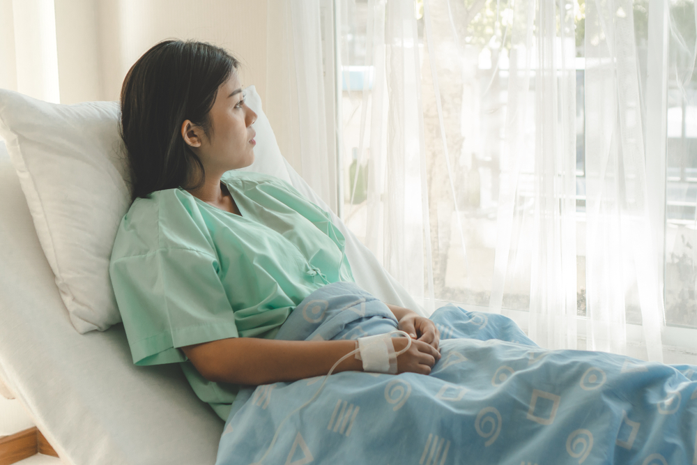 woman recovering in a hospital bed