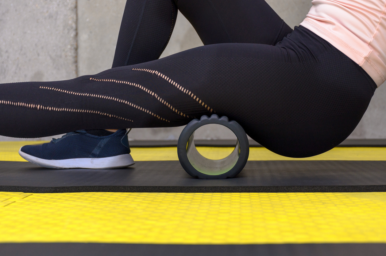 woman foam rolling her legs