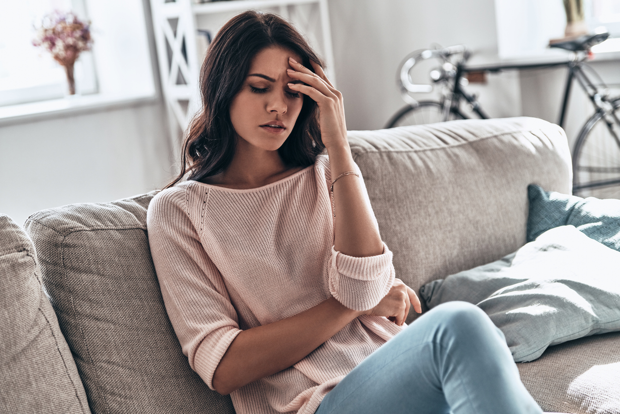 woman in pain on a sofa