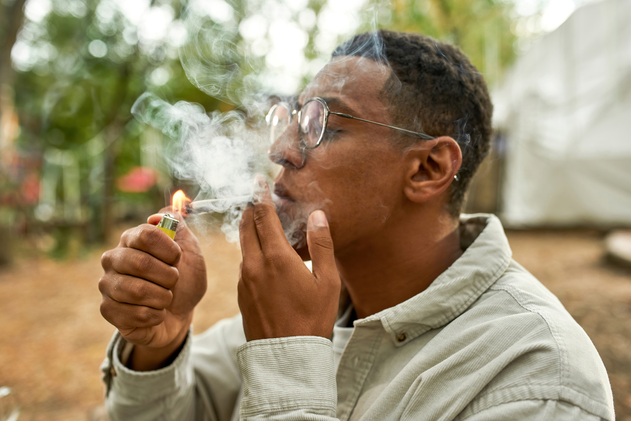 man lighting a joint