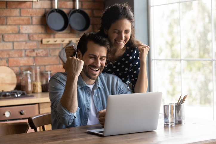 couple celebrating good news that they've just read online