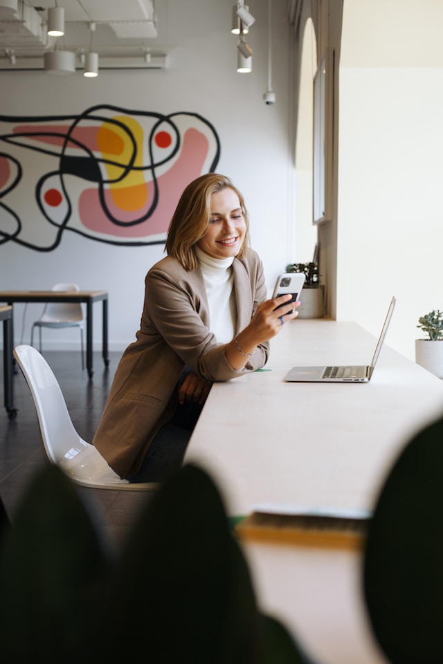 woman reading a text at work