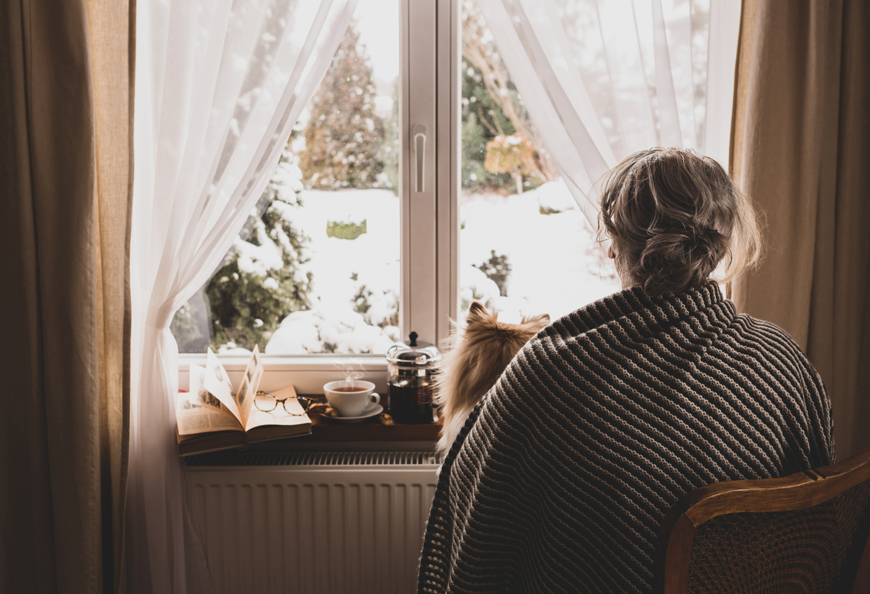 woman suffering from seasonal affective disorder holding her dog