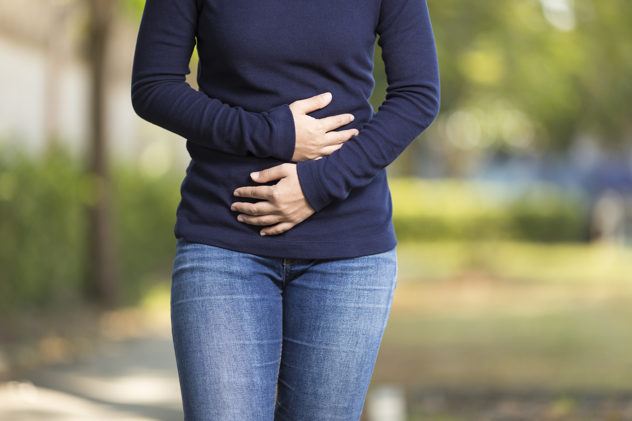 woman gripping her midsection due to endometriosis pain