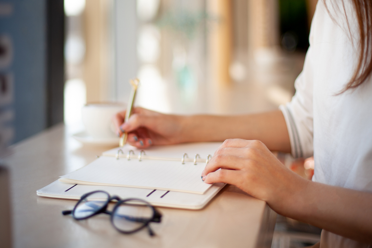 woman using a journal to track ovulation