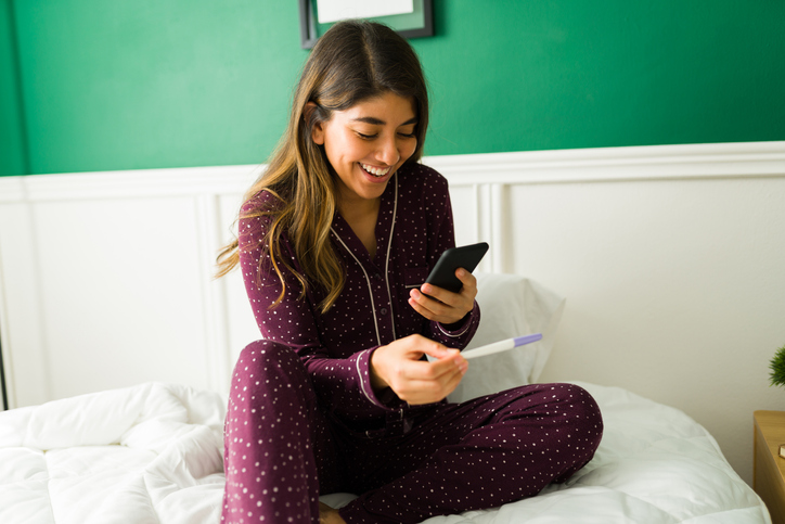 woman reviewing results of an at-home medical test on her phone