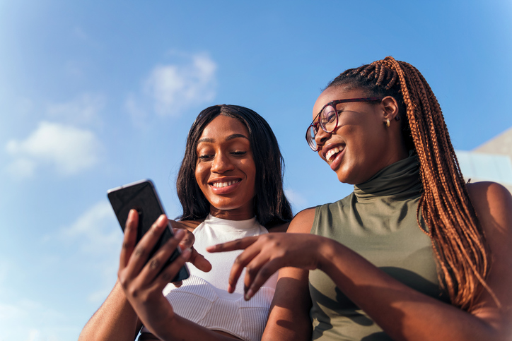 women looking at a cell phone