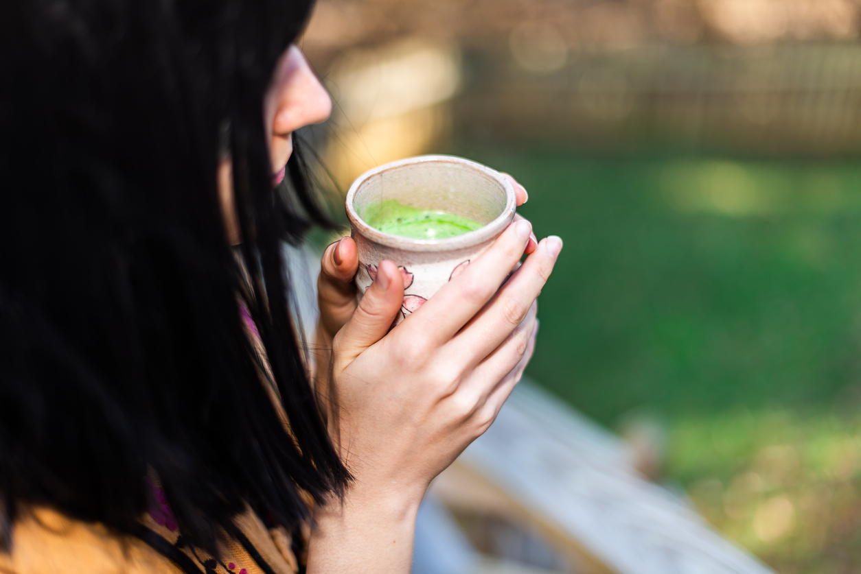 woman drinking matcha in a hand-thrown ceramic mug