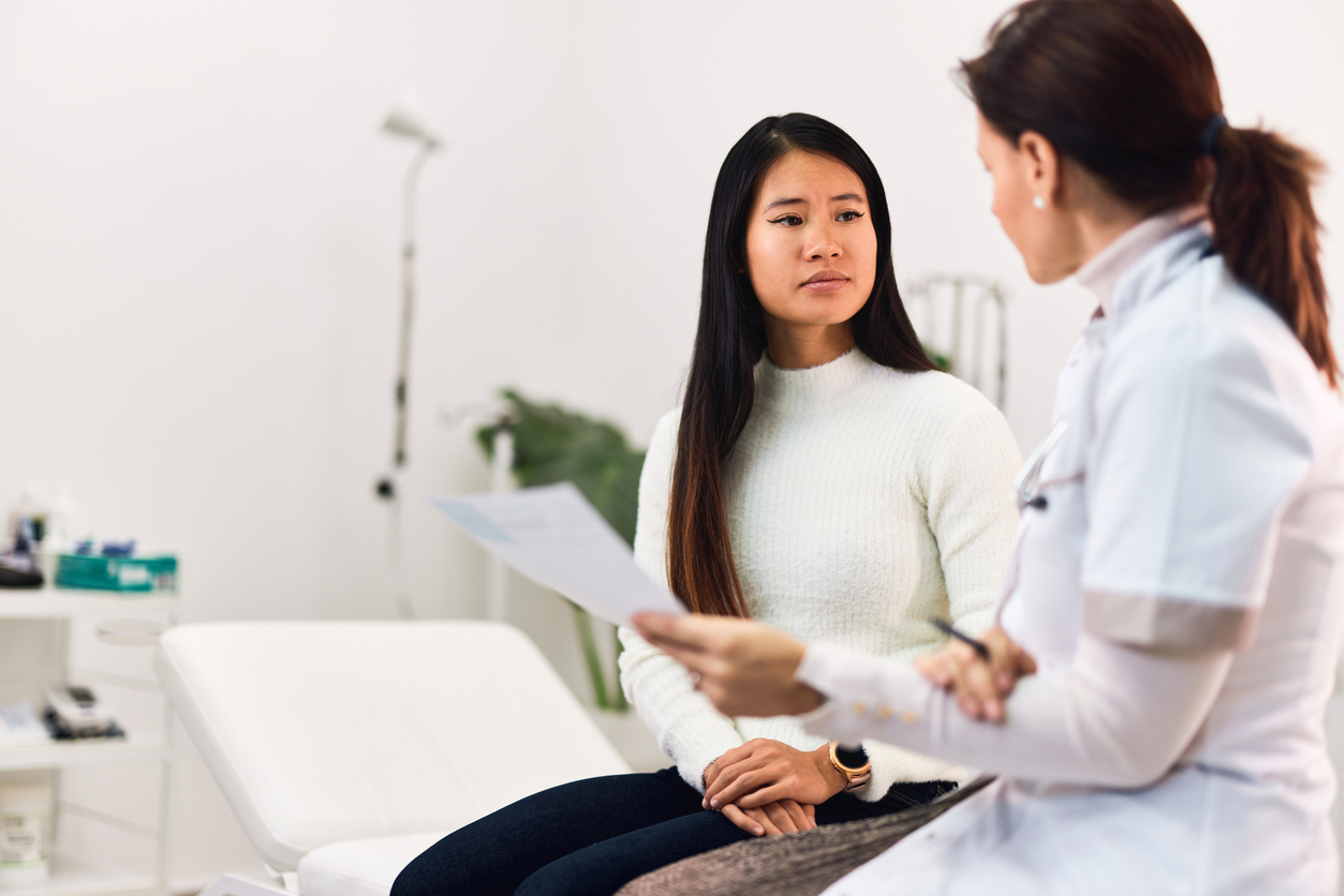 doctor discussing colorectal cancer with her young adult patient