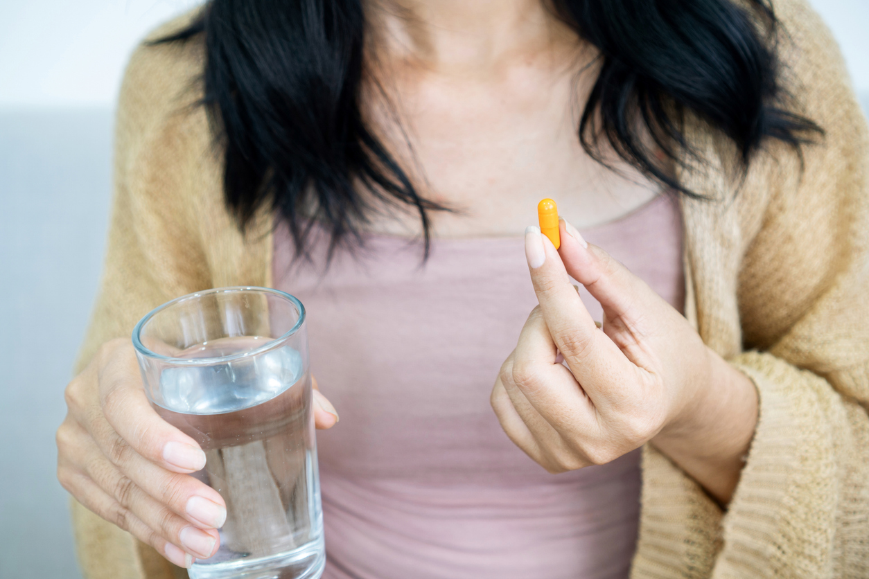 woman taking a pill