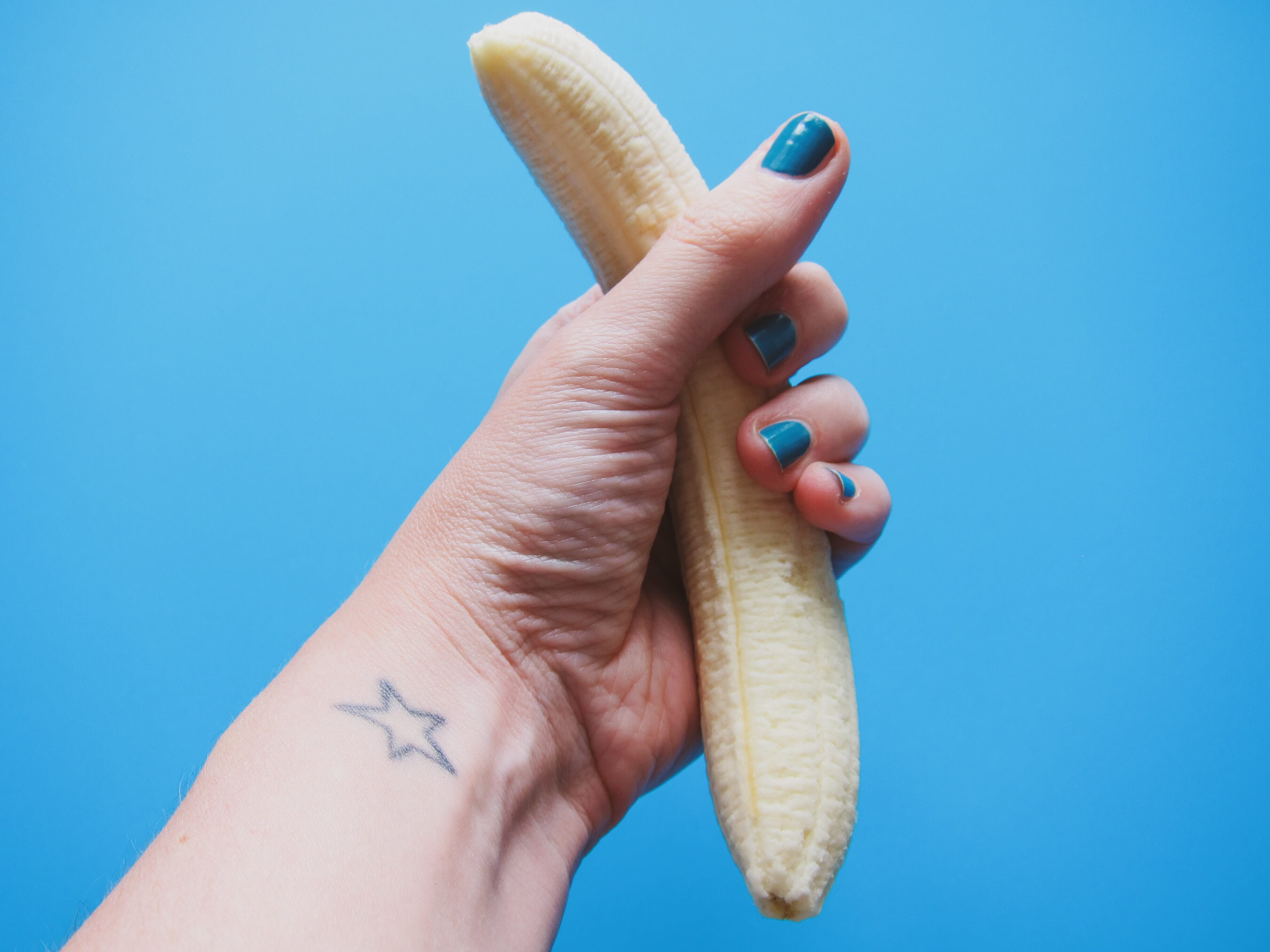 woman holding a peeled banana