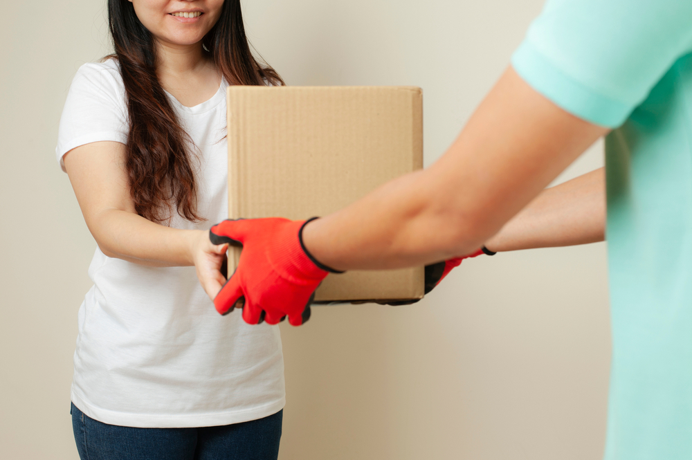 woman receiving a box of ivf meds