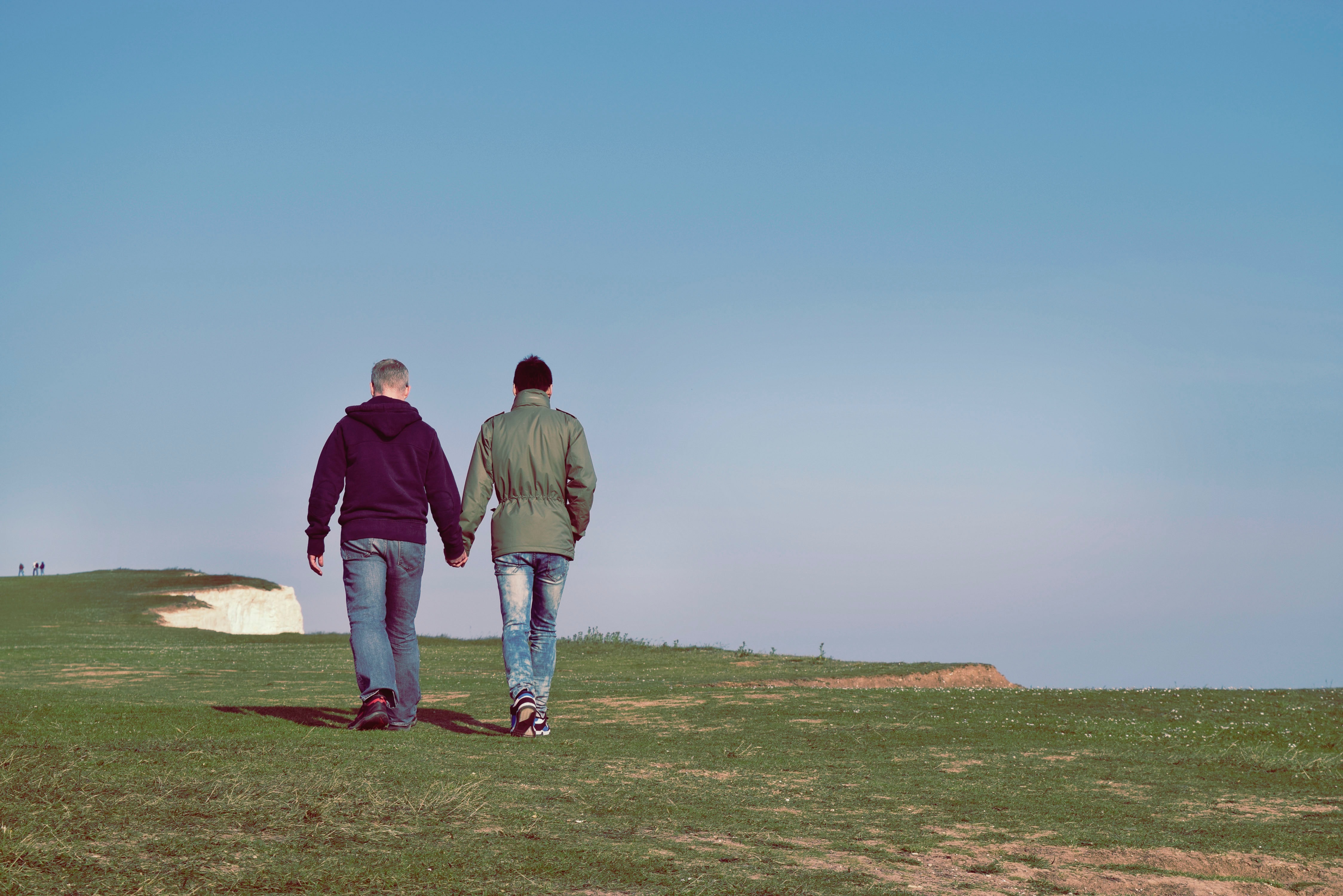 gay couple walking on a cliff