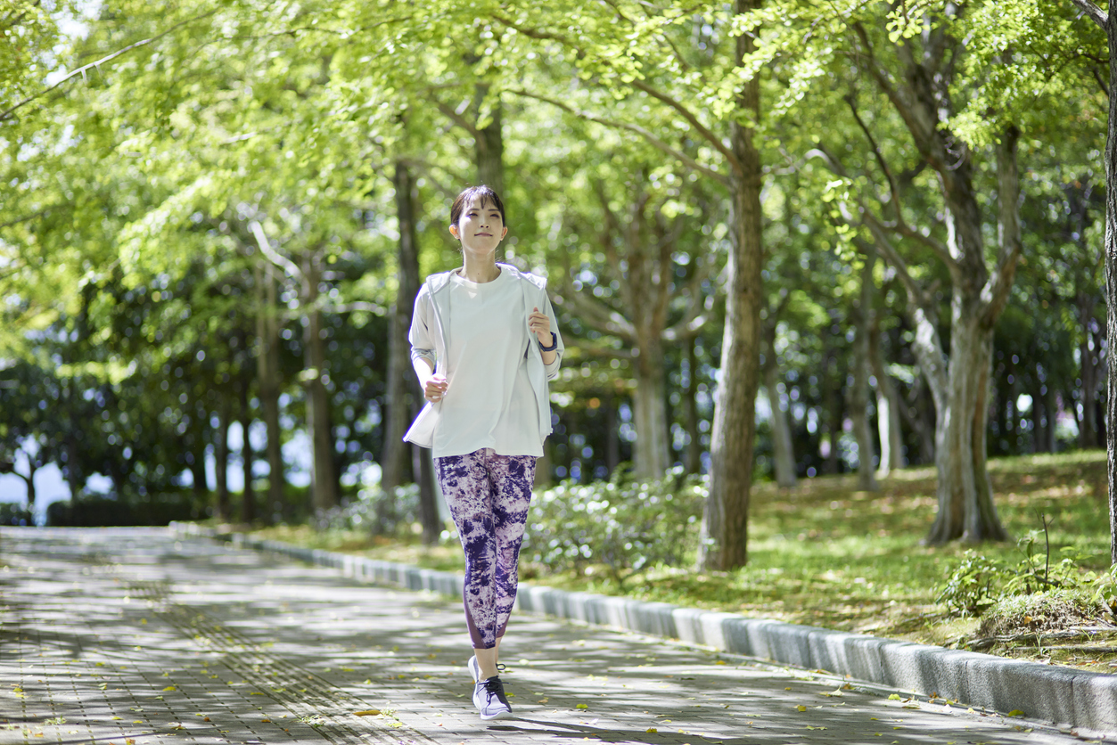 woman speed walking in a park