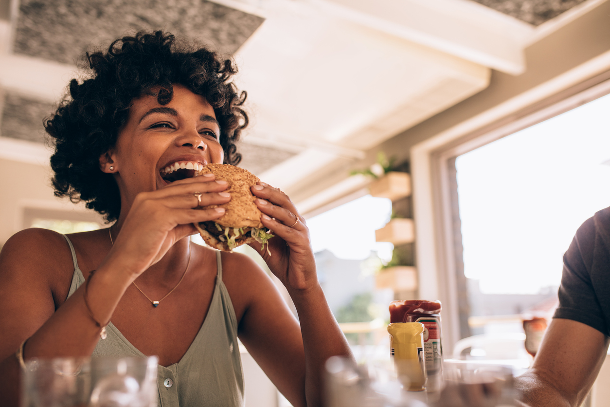 woman eating a hamburger