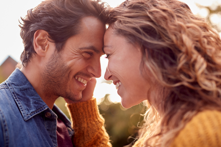 couple touching foreheads intimately outdoors