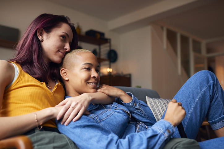 couple cuddling in front of the tv