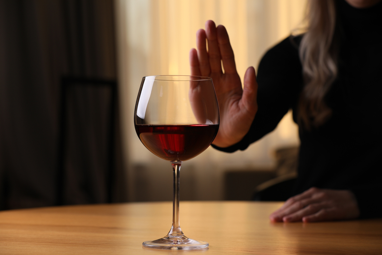 woman abstaining from a glass of wine during dry january