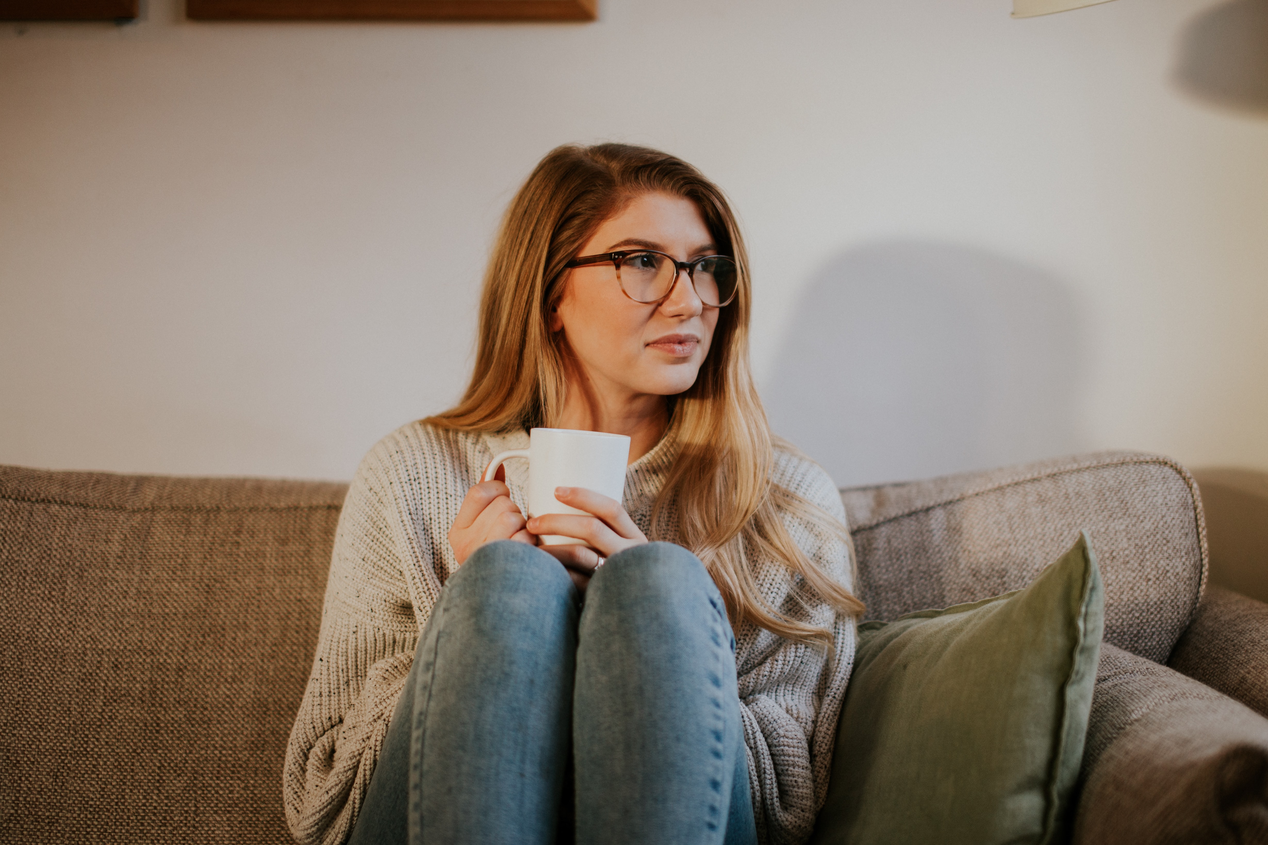 woman drinking tea on a sofa