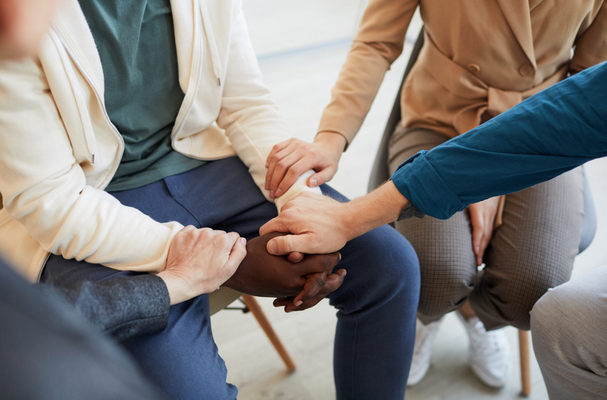 holding hands in a support group